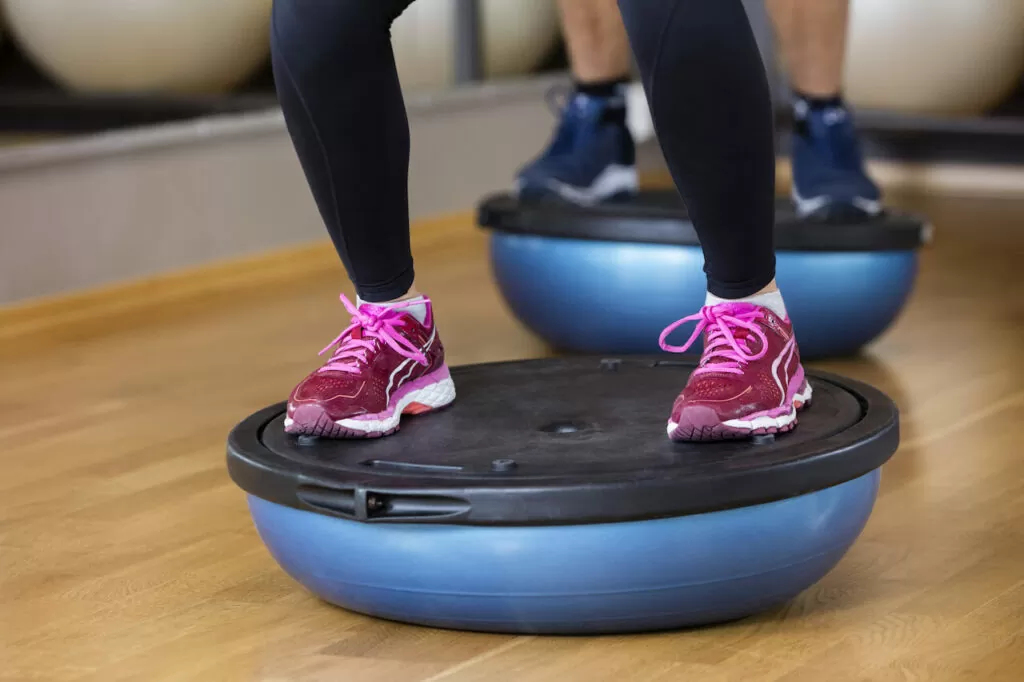 Low Section Of Woman Standing On Bosu Ball